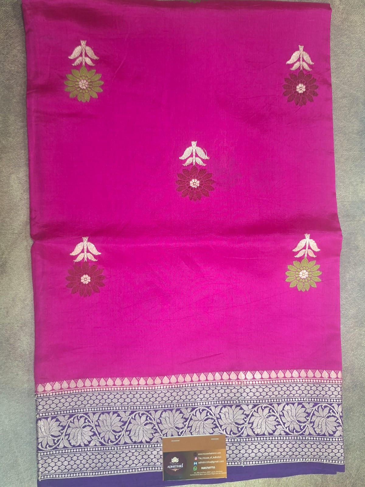 Pink fabric with floral patterns on a gray surface