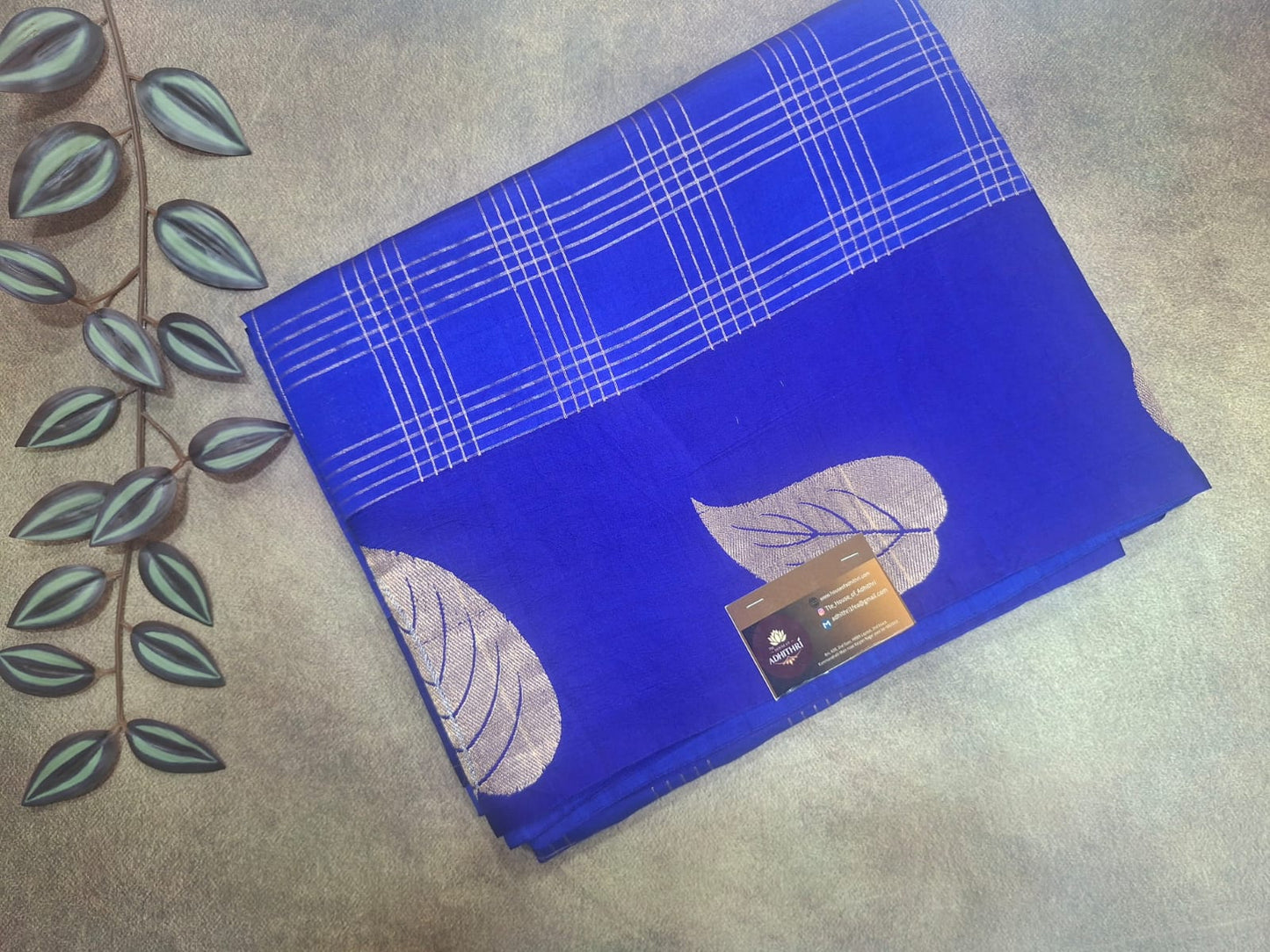 Blue fabric with leaf patterns on a textured surface