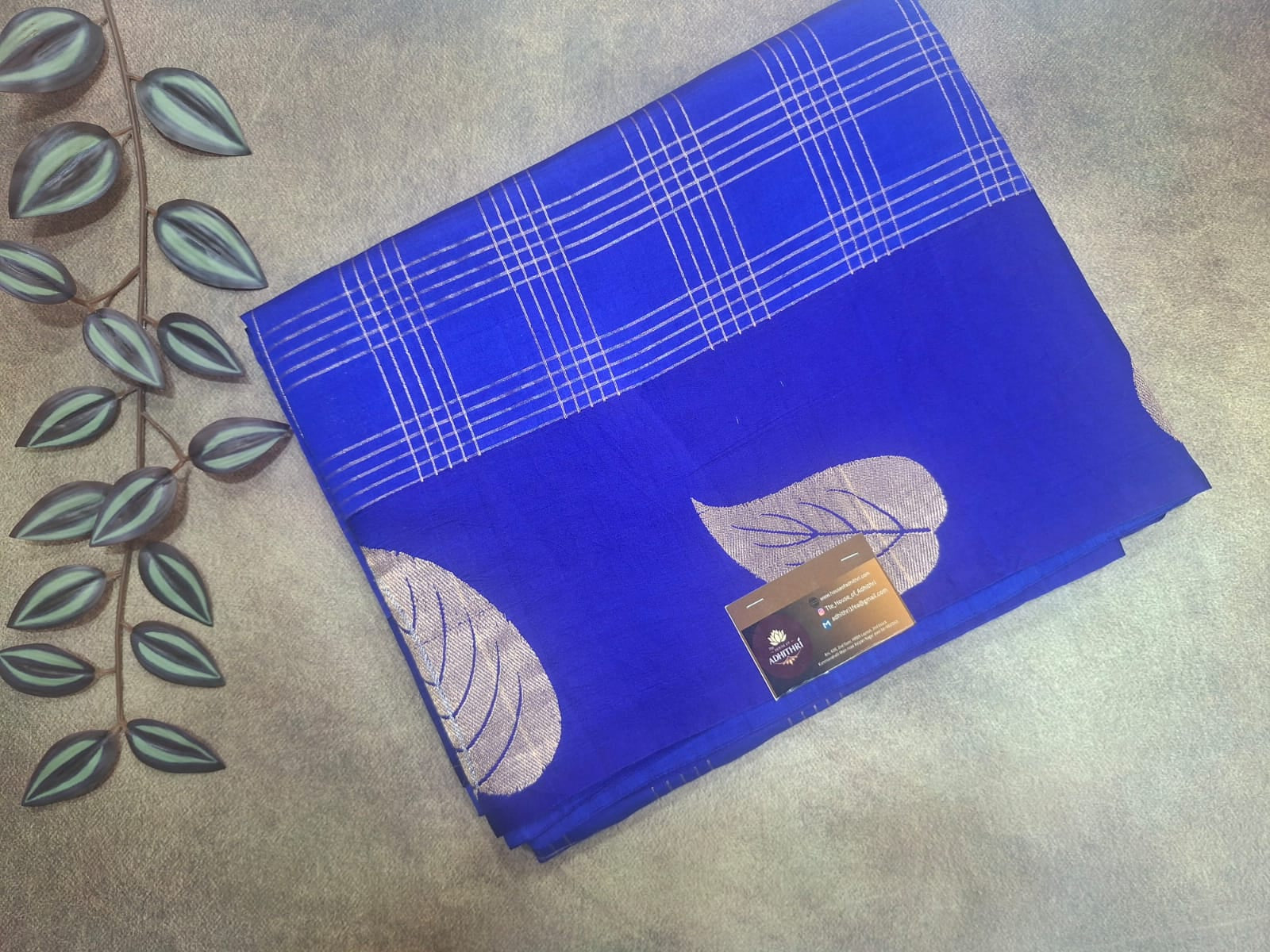 Blue fabric with leaf patterns on a textured surface