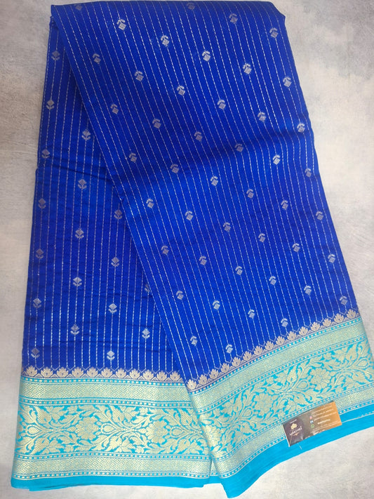 Blue saree with white patterns on a light gray background