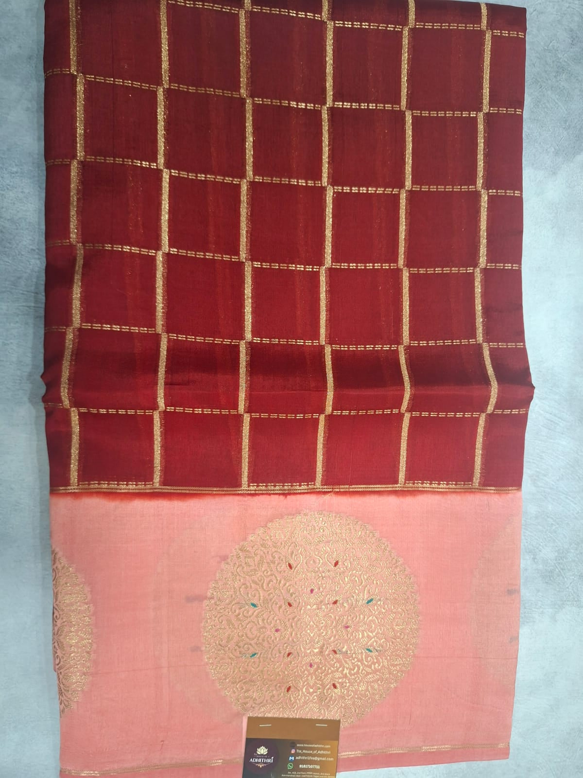 Saree with pink and red checkered pattern on a light blue background