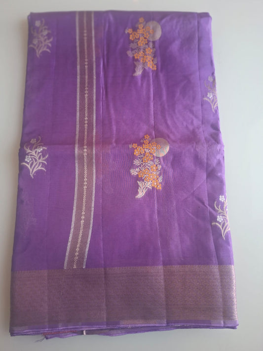 Purple fabric with floral embroidery on a white background