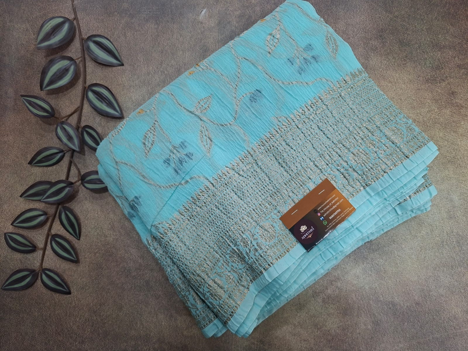 Turquoise fabric with a subtle pattern on a brown surface