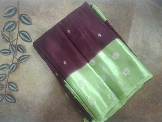 Green and maroon fabric with white patterns on a textured surface