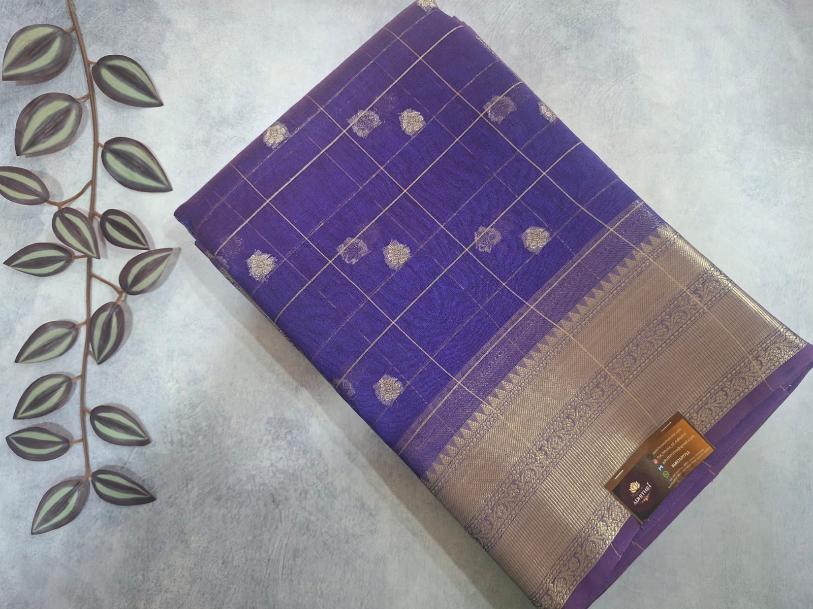 Purple fabric with gold patterns on a textured surface