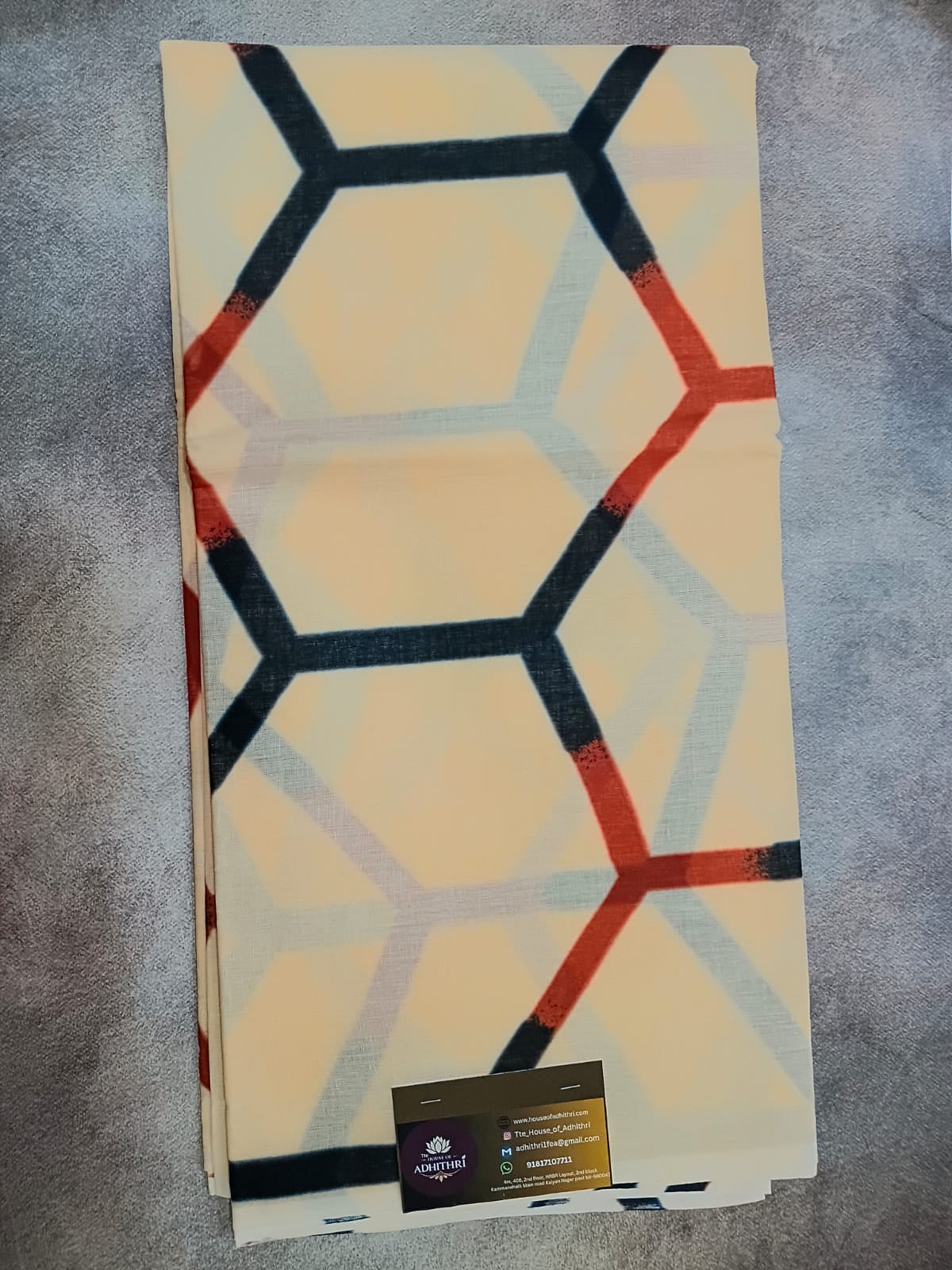 Folded rug with geometric pattern on a textured surface