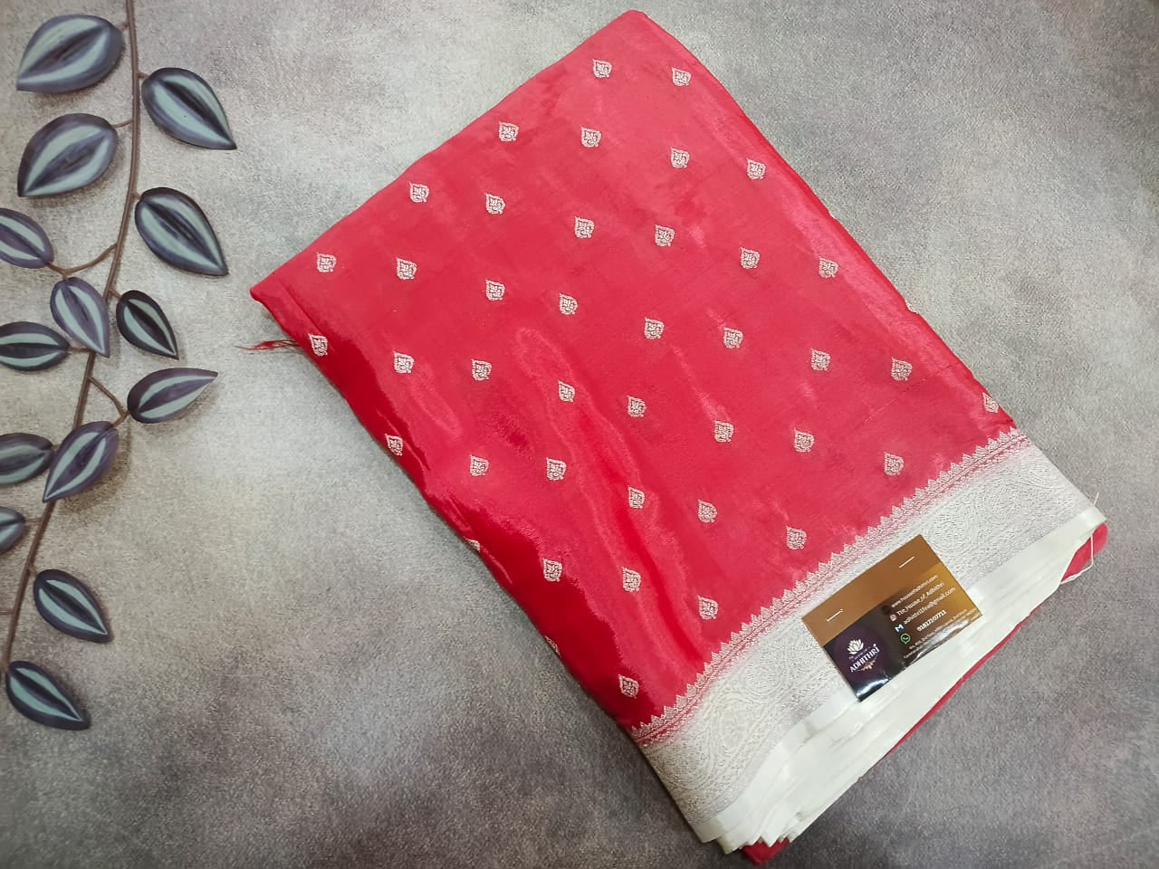 Red fabric with white patterns on a gray surface