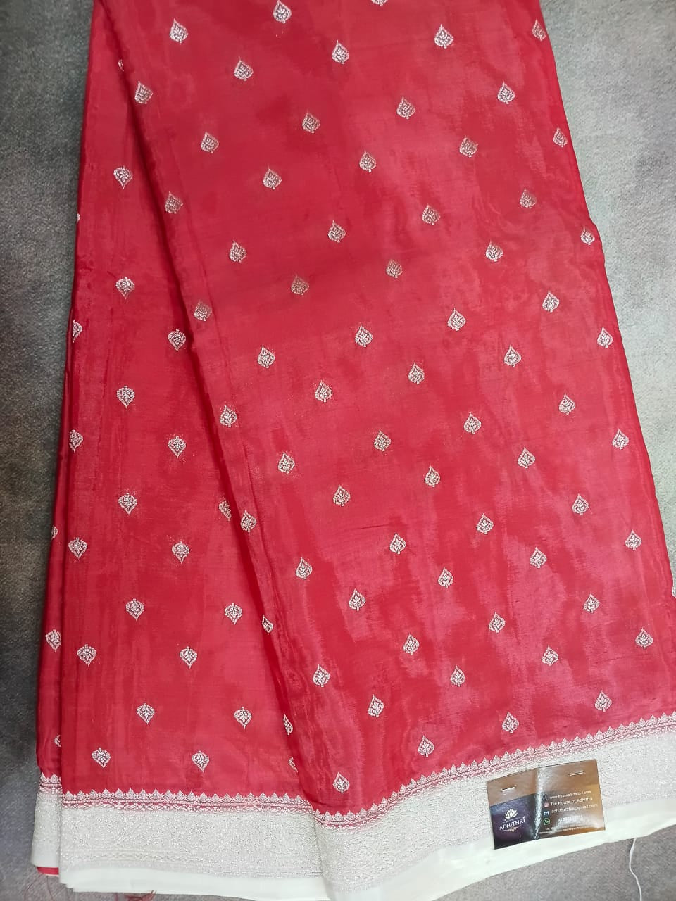 Red fabric with white patterns on a gray surface