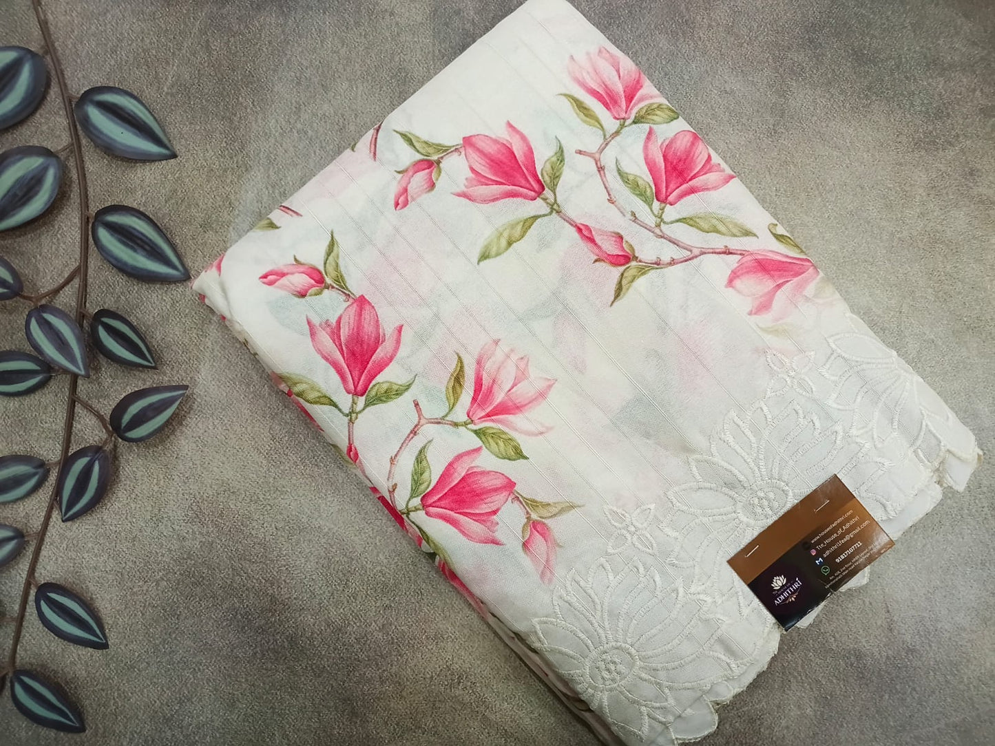 Floral-patterned fabric with a tag on a gray surface