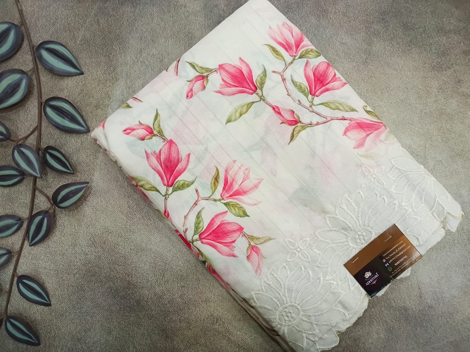 Floral-patterned fabric with a tag on a gray surface