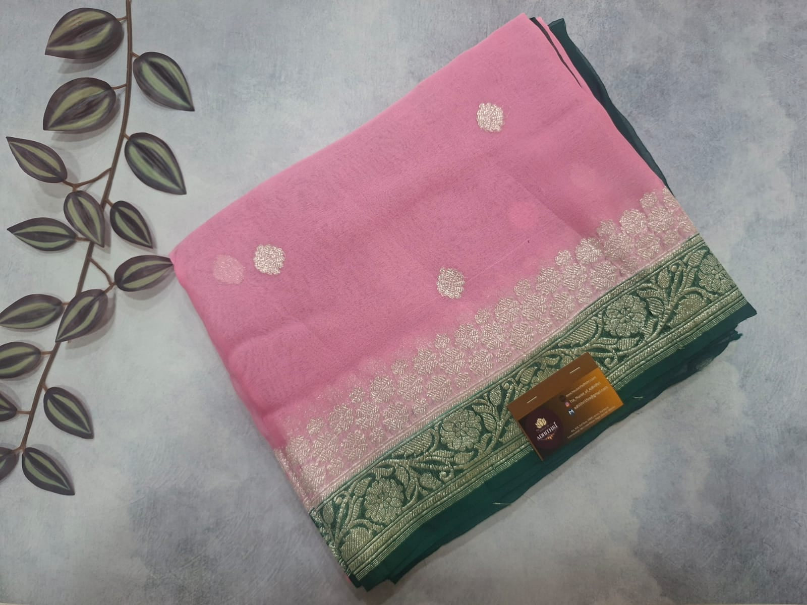 Pink and green fabric with floral patterns on a gray surface