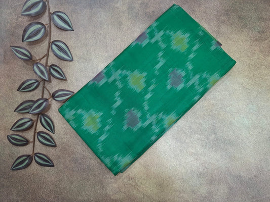 Green fabric with a pattern on a textured surface