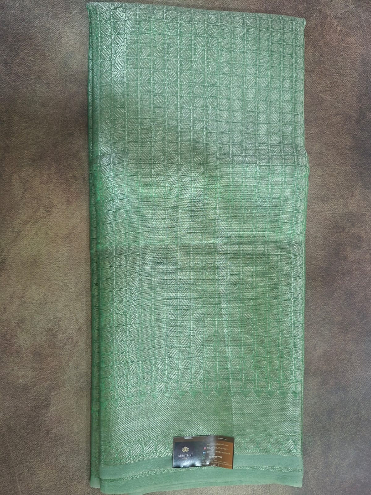 Green mesh pouch with a metal clip on a brown surface