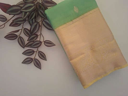 Beige and green fabric with floral patterns on a plain background