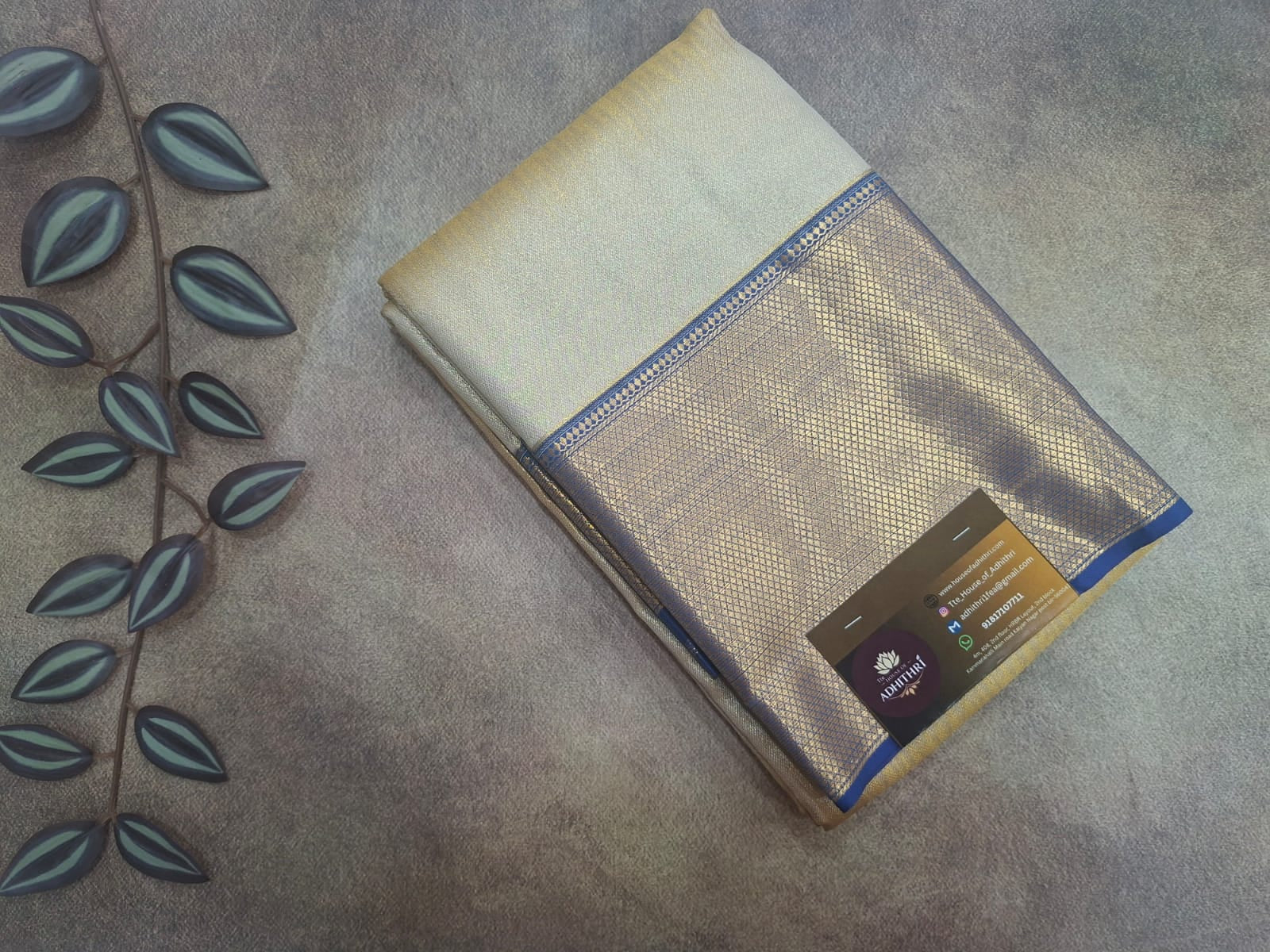 Folded beige fabric with a brand label on a textured surface
