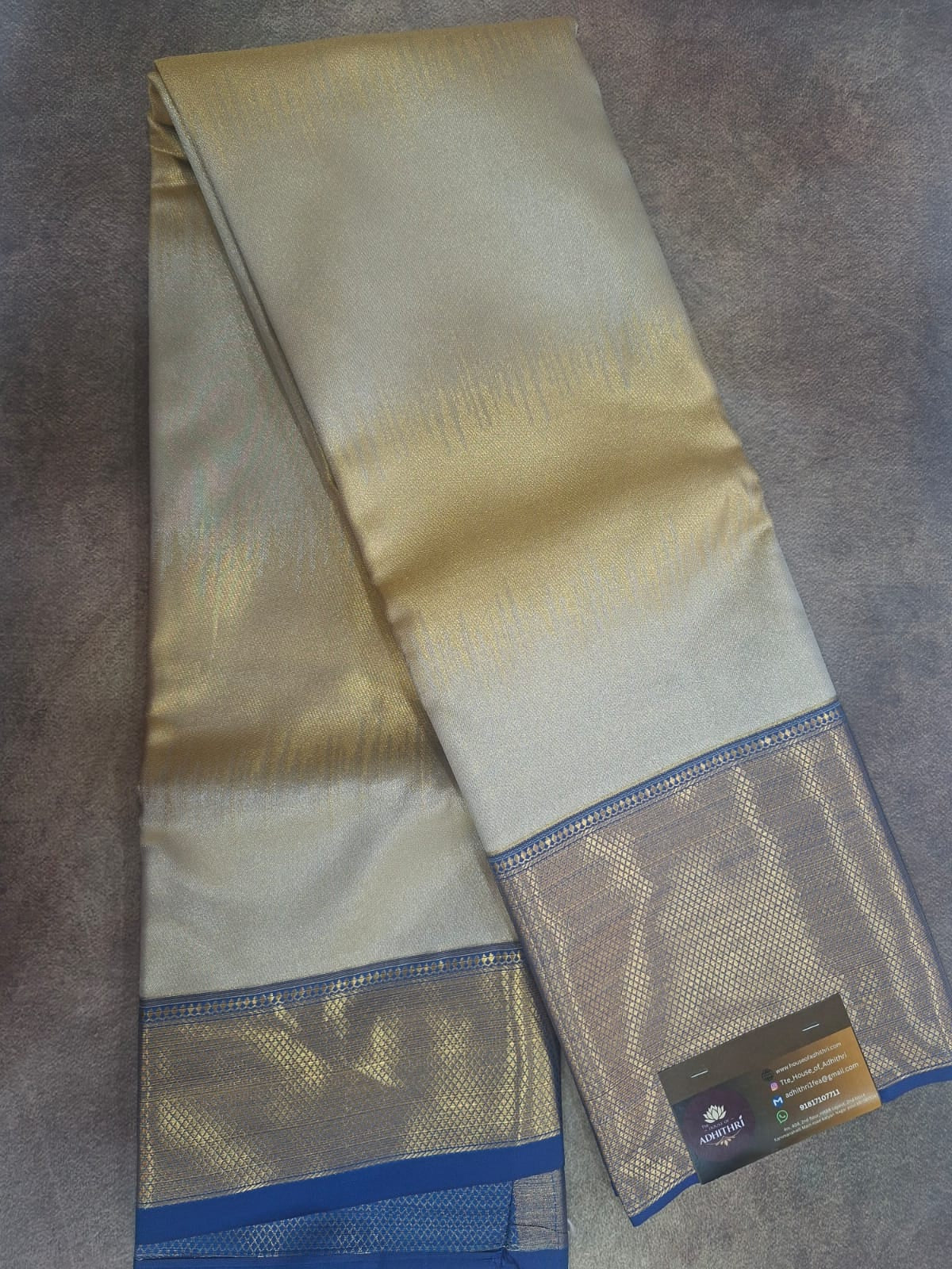 Beige fabric with blue border on a gray surface