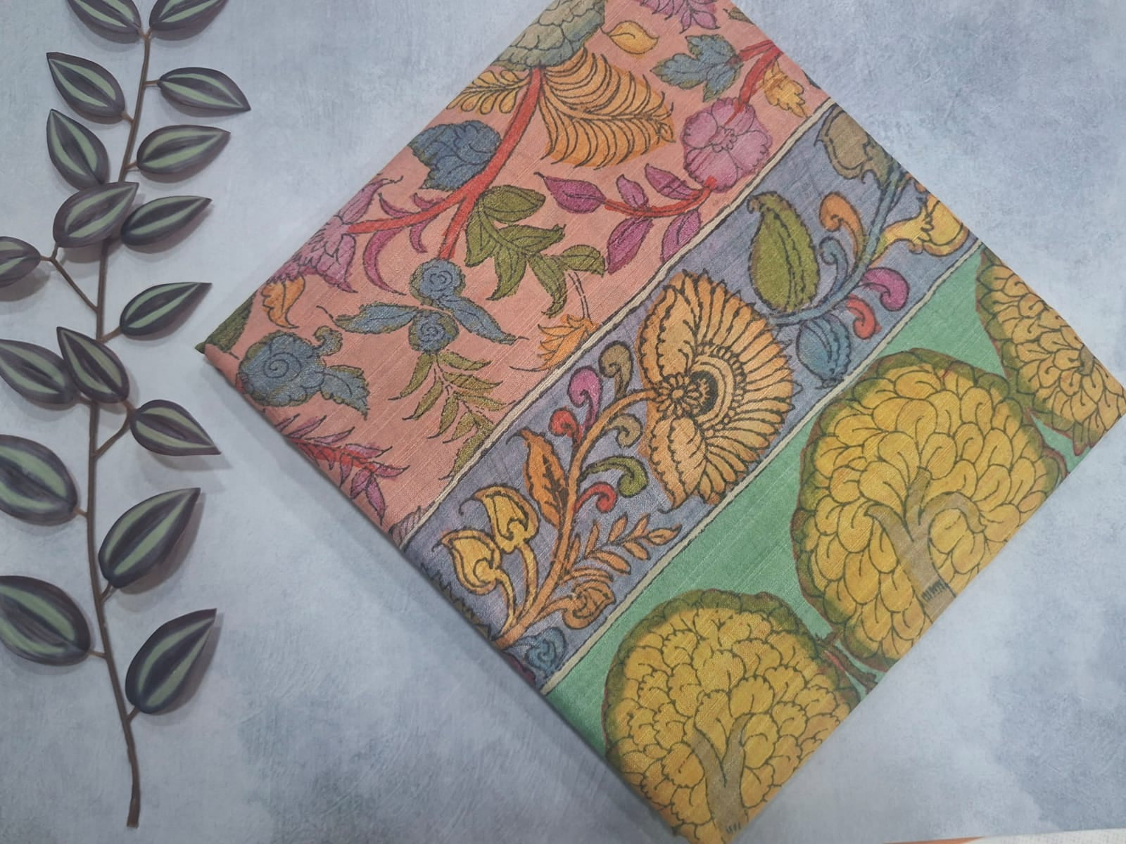 Colorful floral patterned fabric on a light gray background