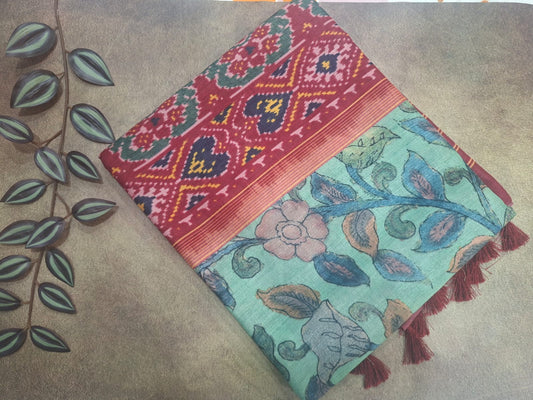 Two patterned cloths on a textured surface with leaves in the background