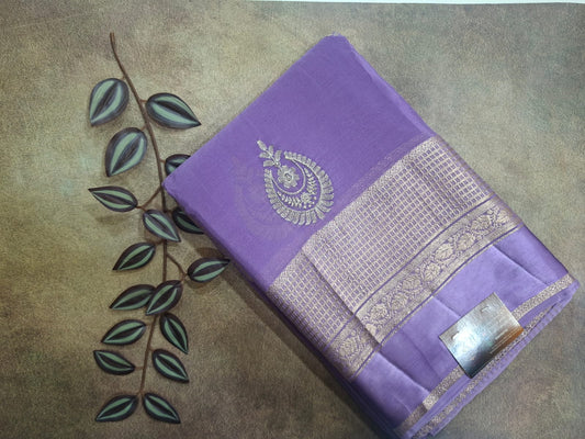 Purple saree with silver embroidery on a textured surface