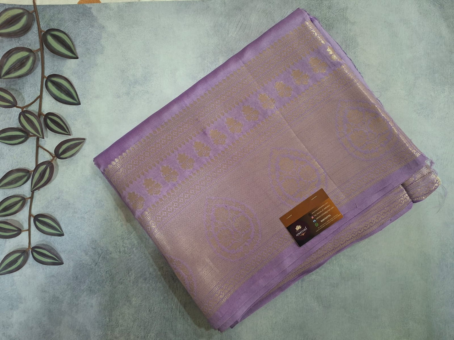 Folded purple fabric with a pattern on a light green background