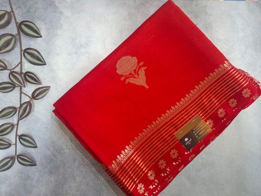 Red fabric with gold patterns on a light gray background