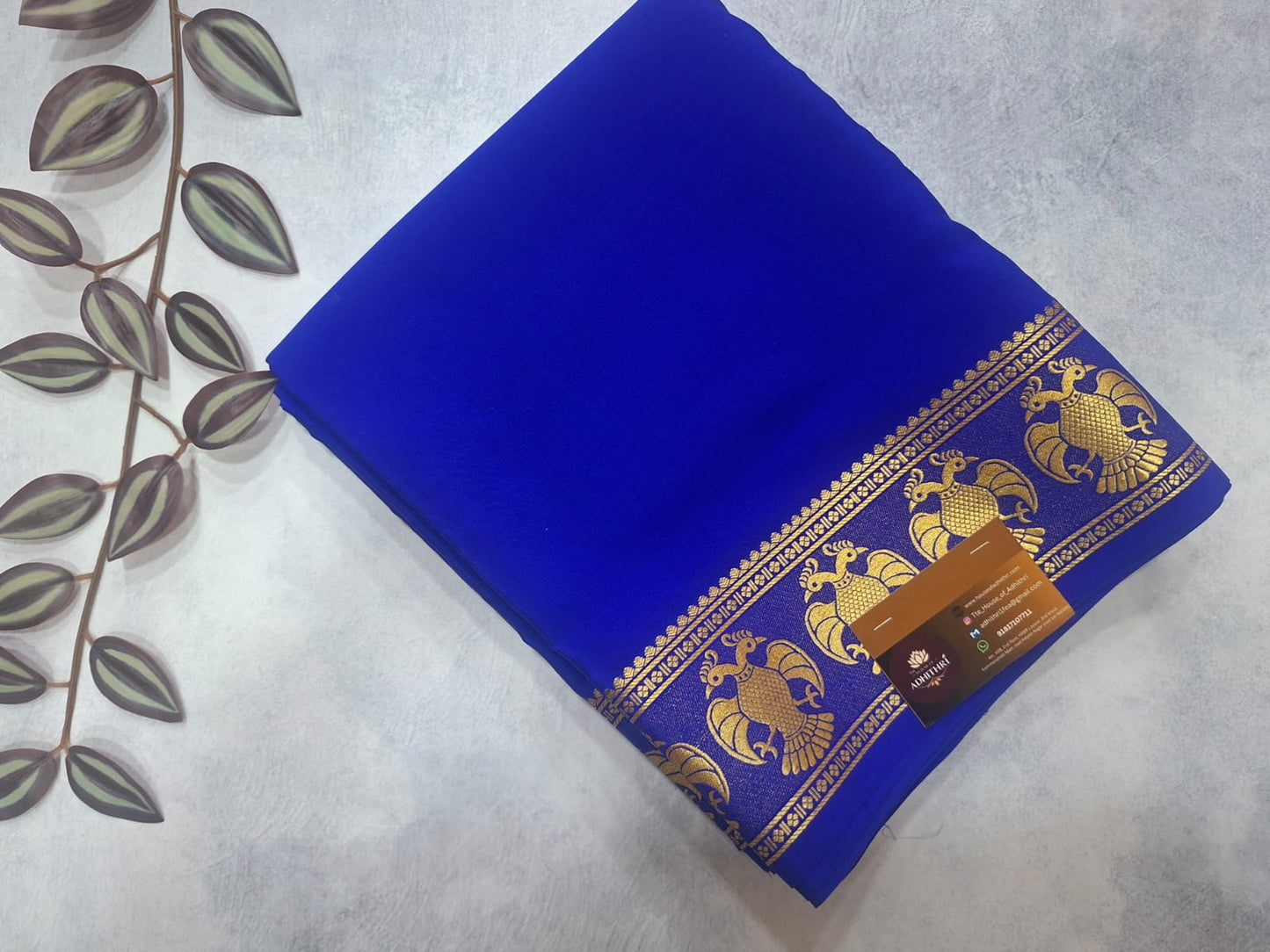 Blue fabric with gold patterns on a textured surface