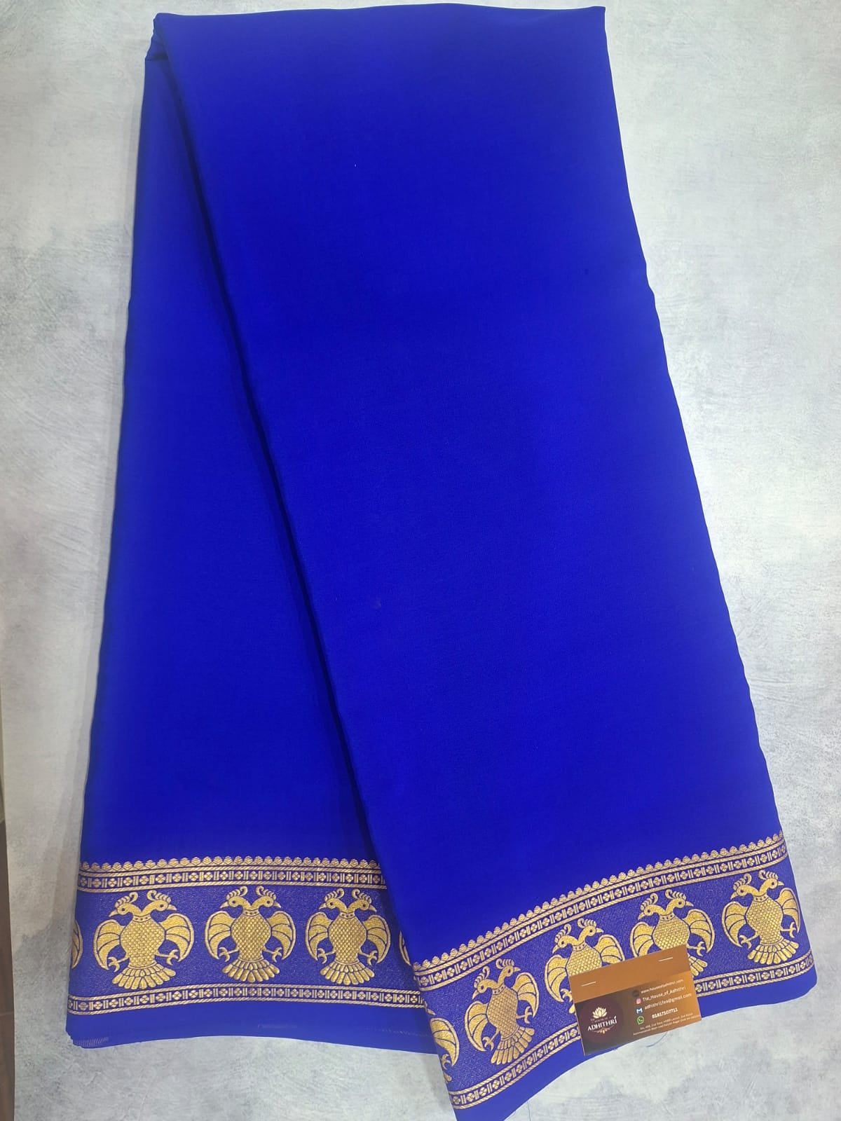 Blue fabric with gold embroidery on a white background
