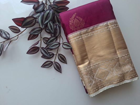 Purple saree with gold border on a white background