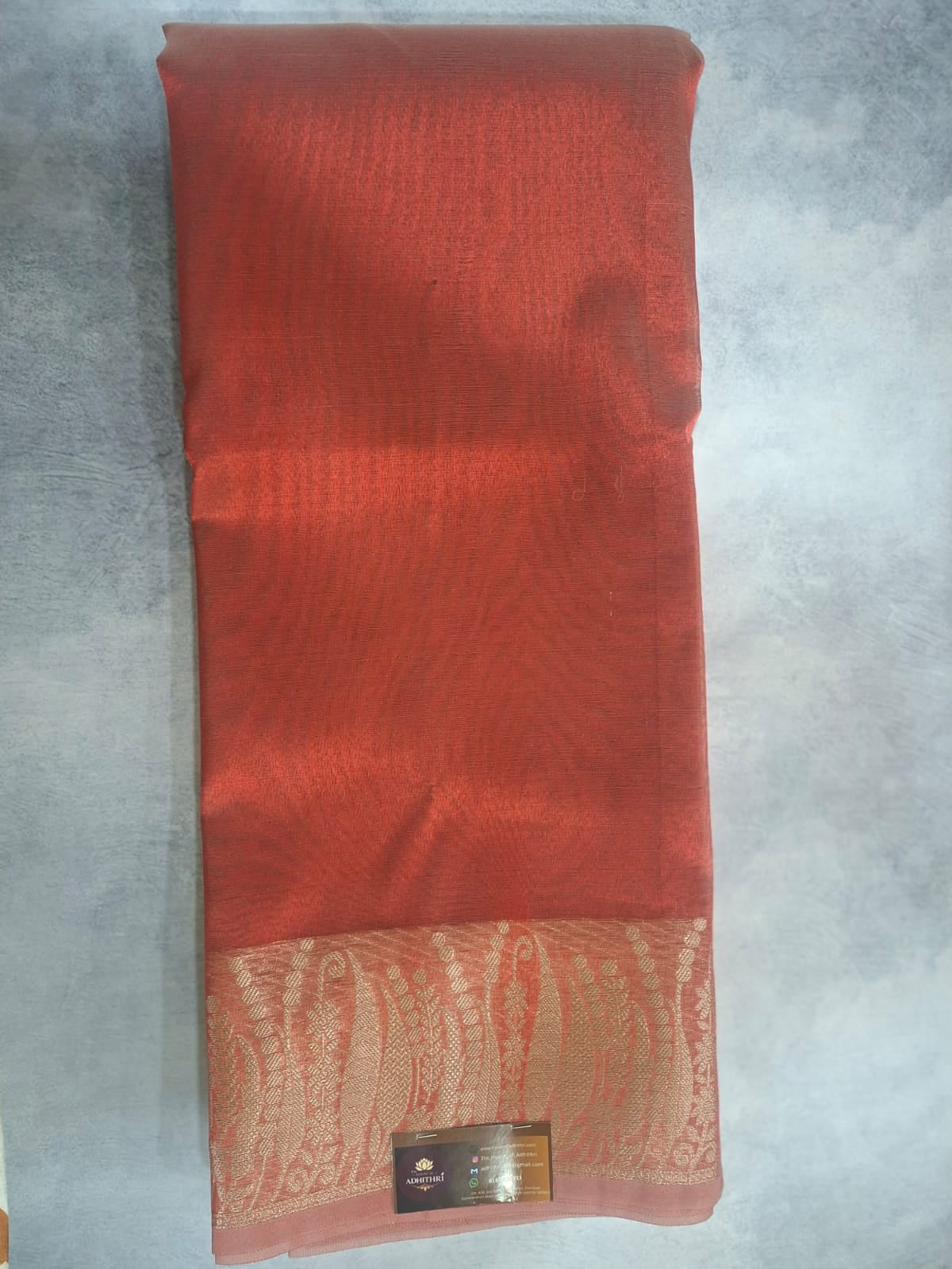 Red fabric with a pattern on a gray surface