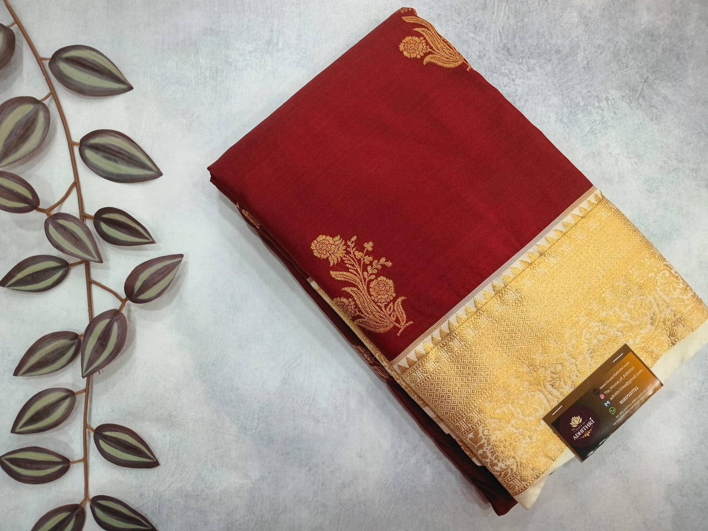 Red and gold fabric with floral patterns on a light gray background
