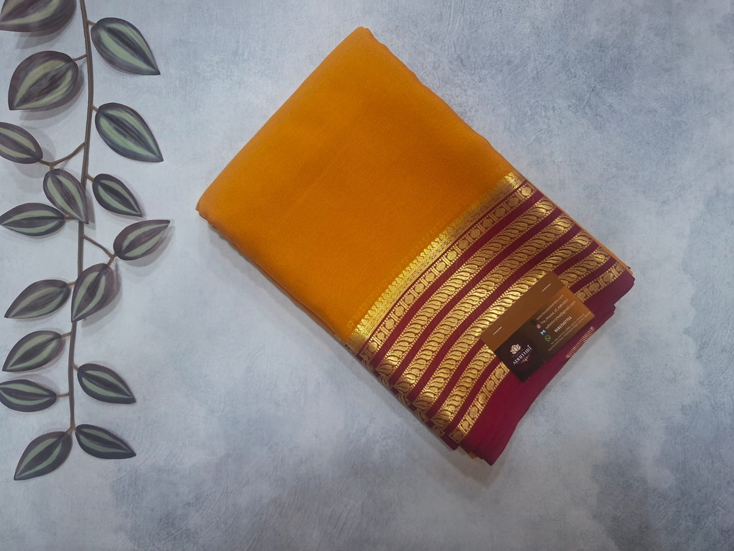 Stack of books with a yellow cover on a textured surface with leaf patterns