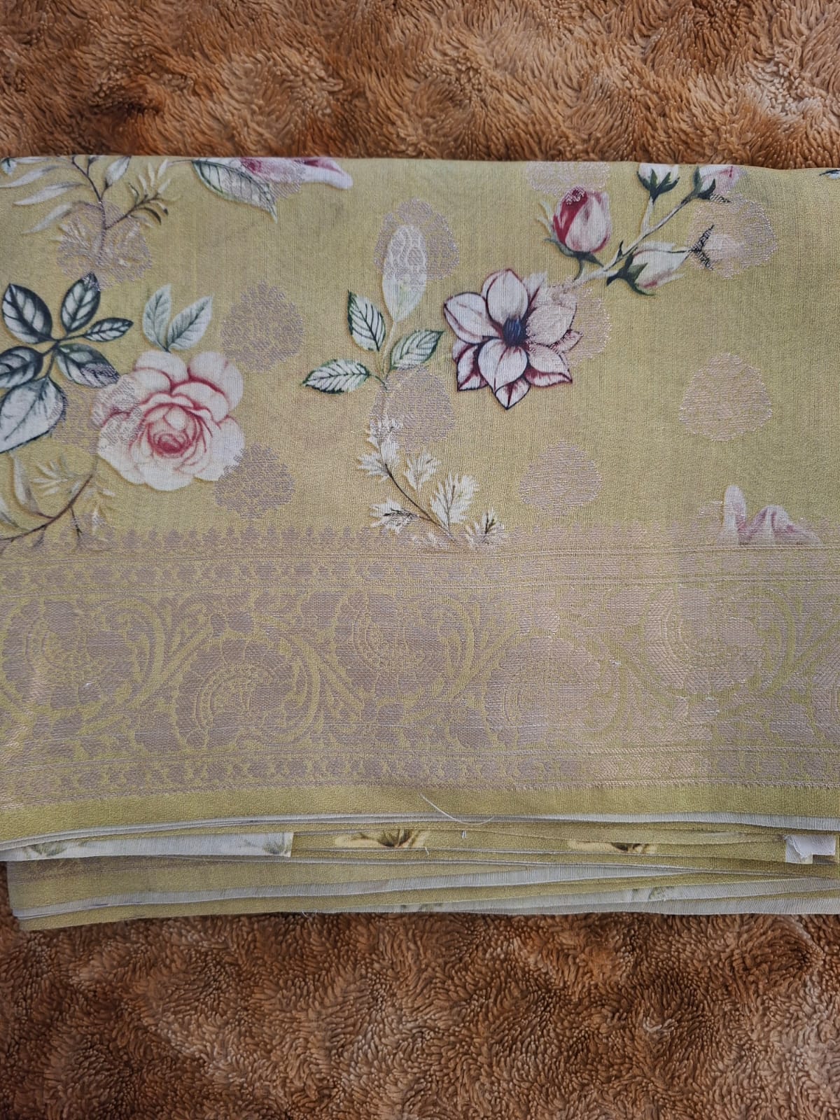 Floral embroidered fabric on a brown surface