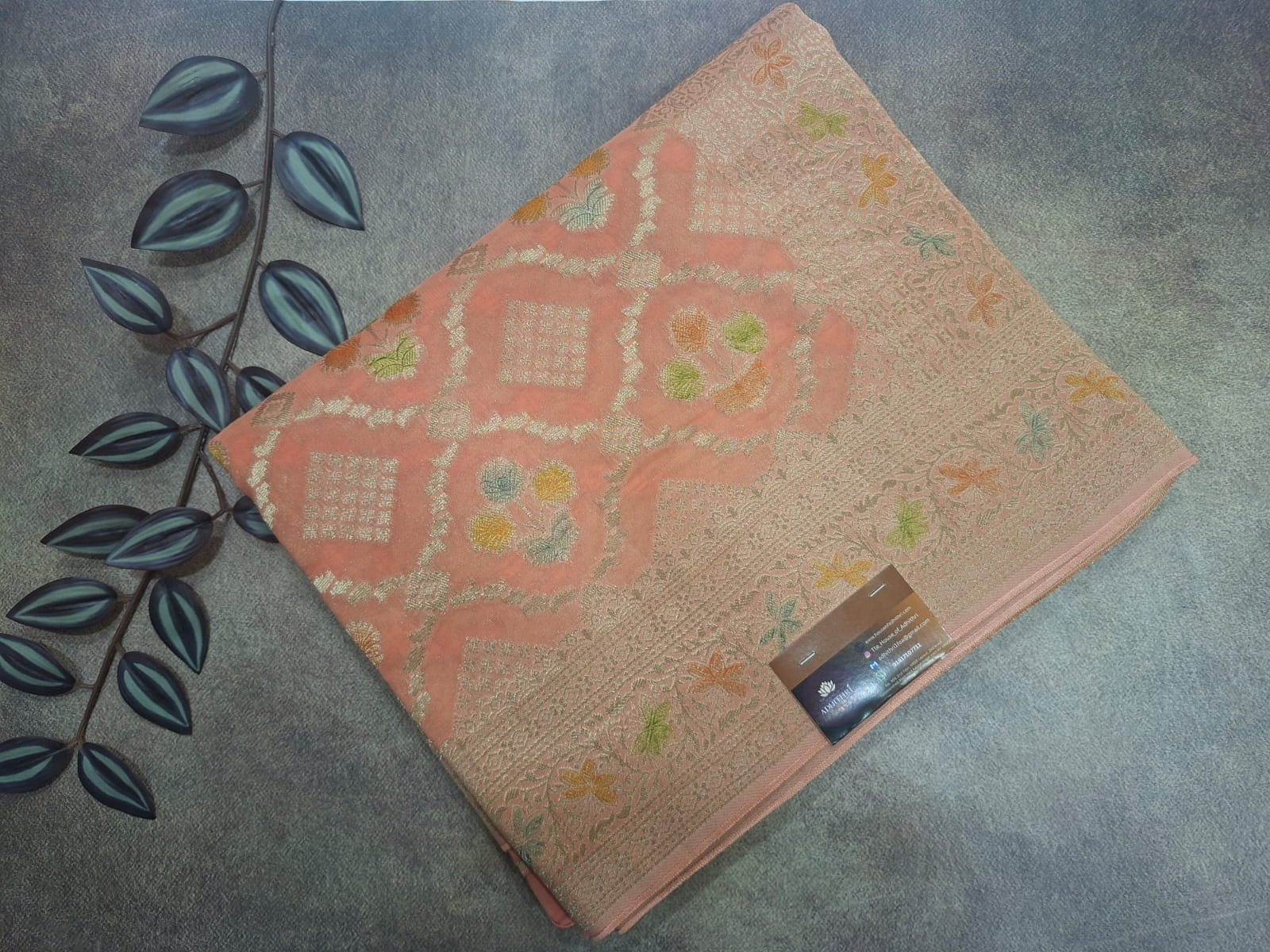 Decorative pink mat with floral patterns on a textured surface