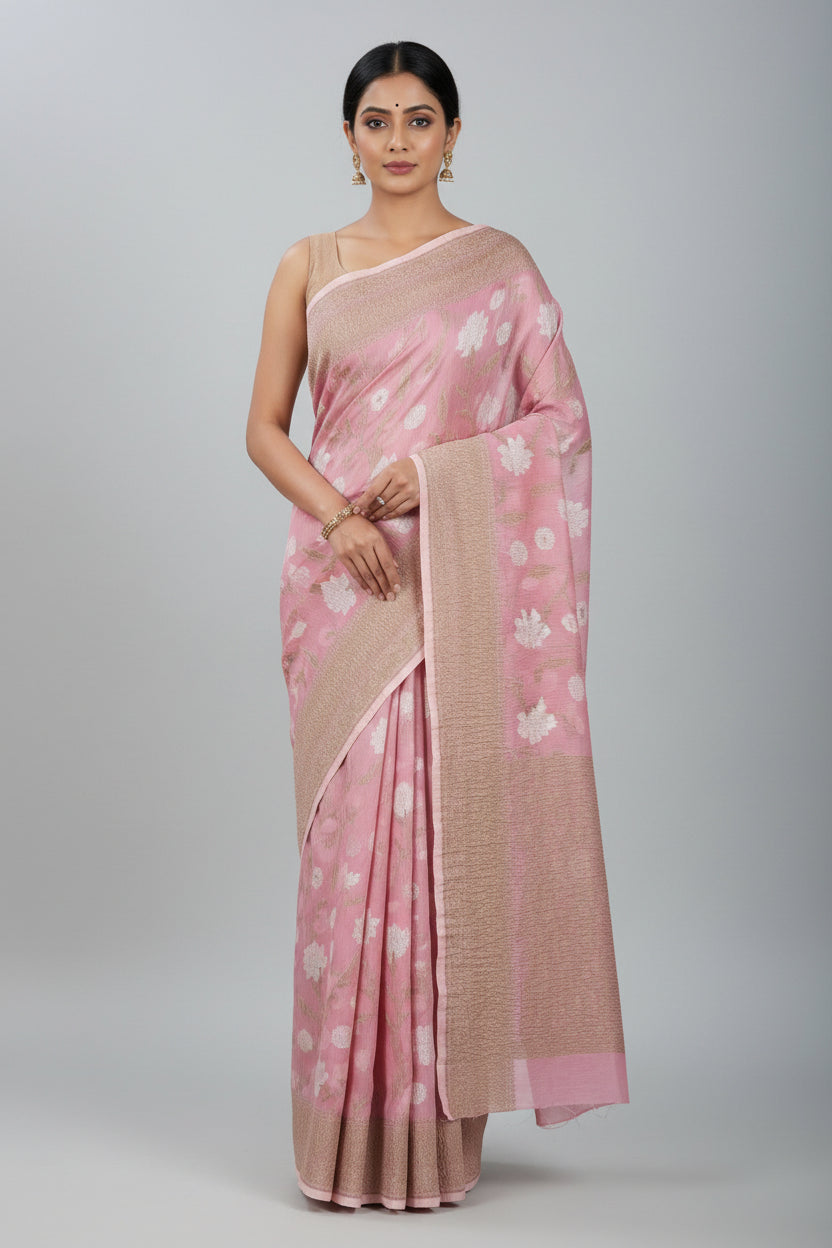 Pink and beige floral patterned fabric with a brand label on a green surface