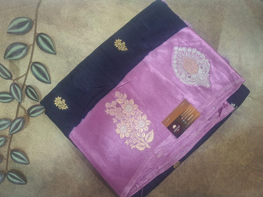 Purple saree with gold embroidery on a brown surface