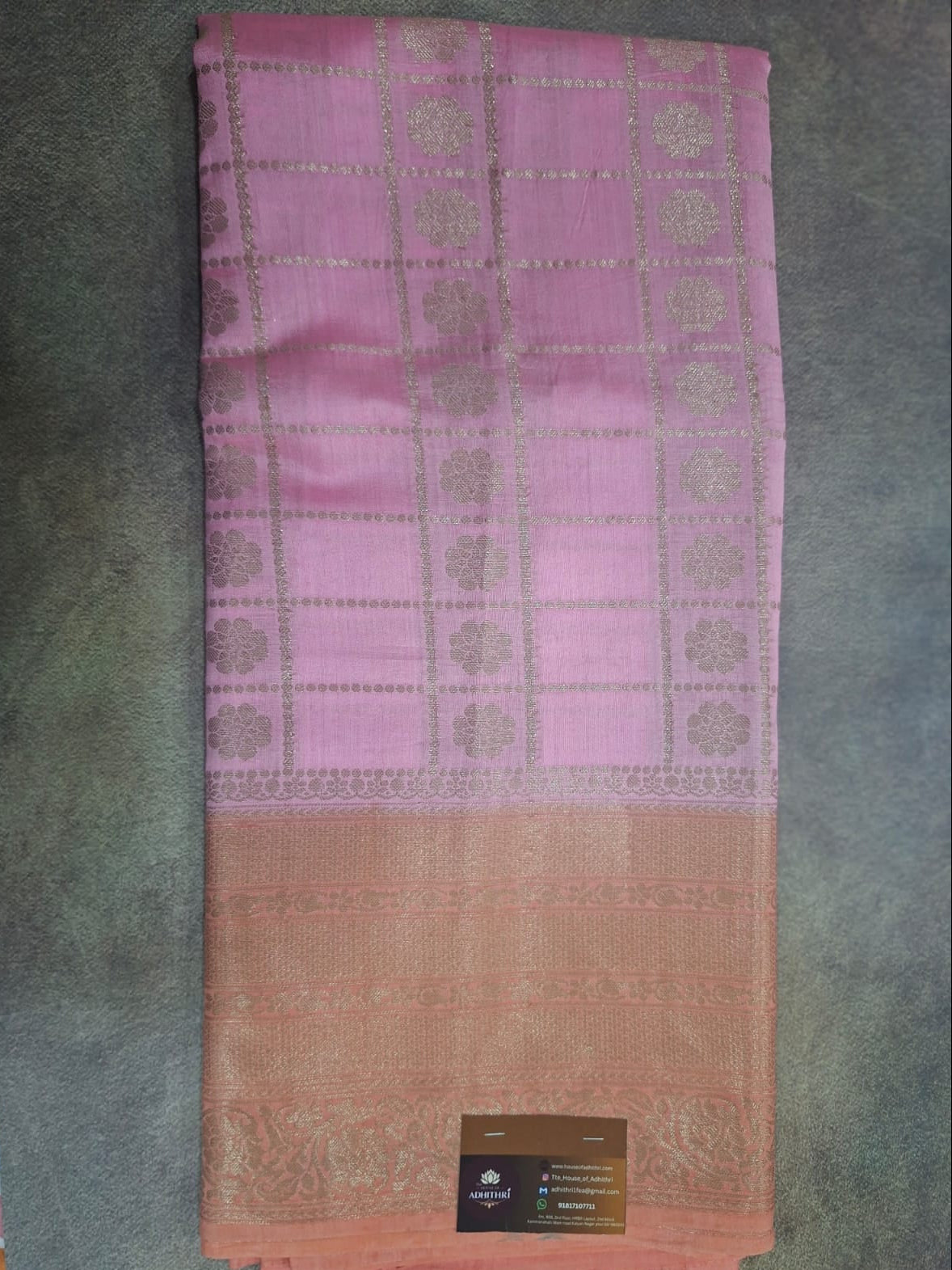 Folded fabric with a gradient from pink to red on a textured surface
