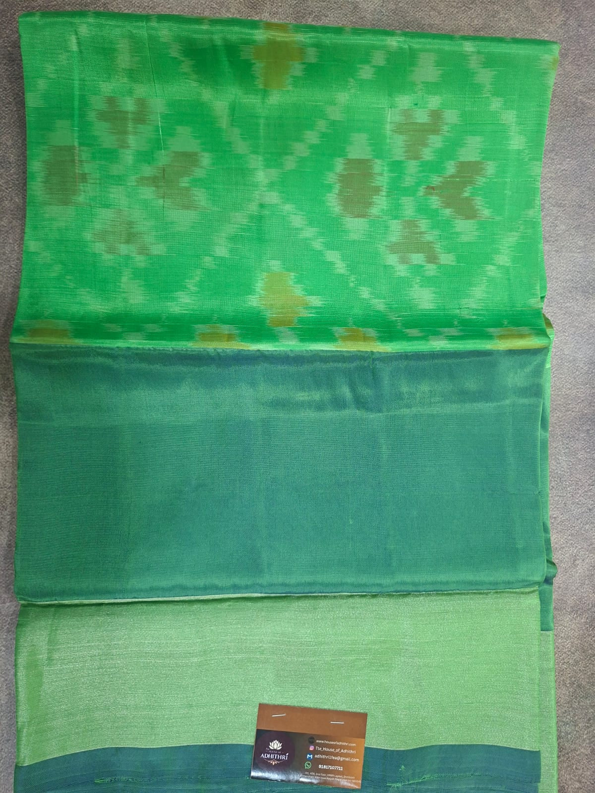 Green fabric with a pattern on a gray surface