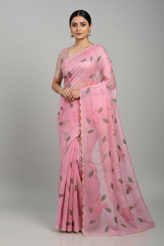 Pink fabric with floral embroidery on a beige background