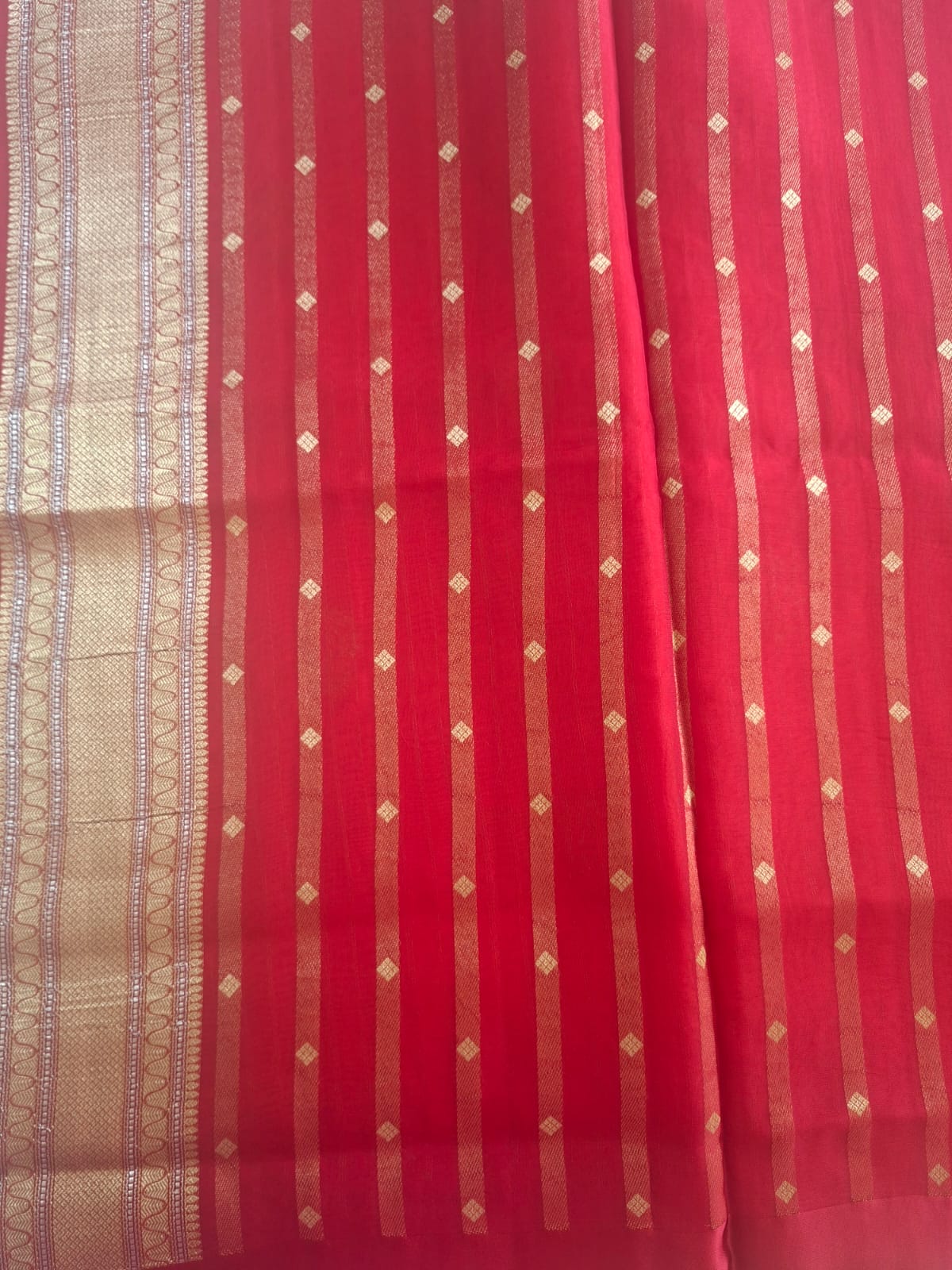 red organza with satin border and copper zari motives