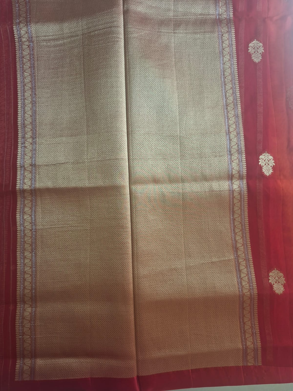 red organza with satin border and copper zari motives