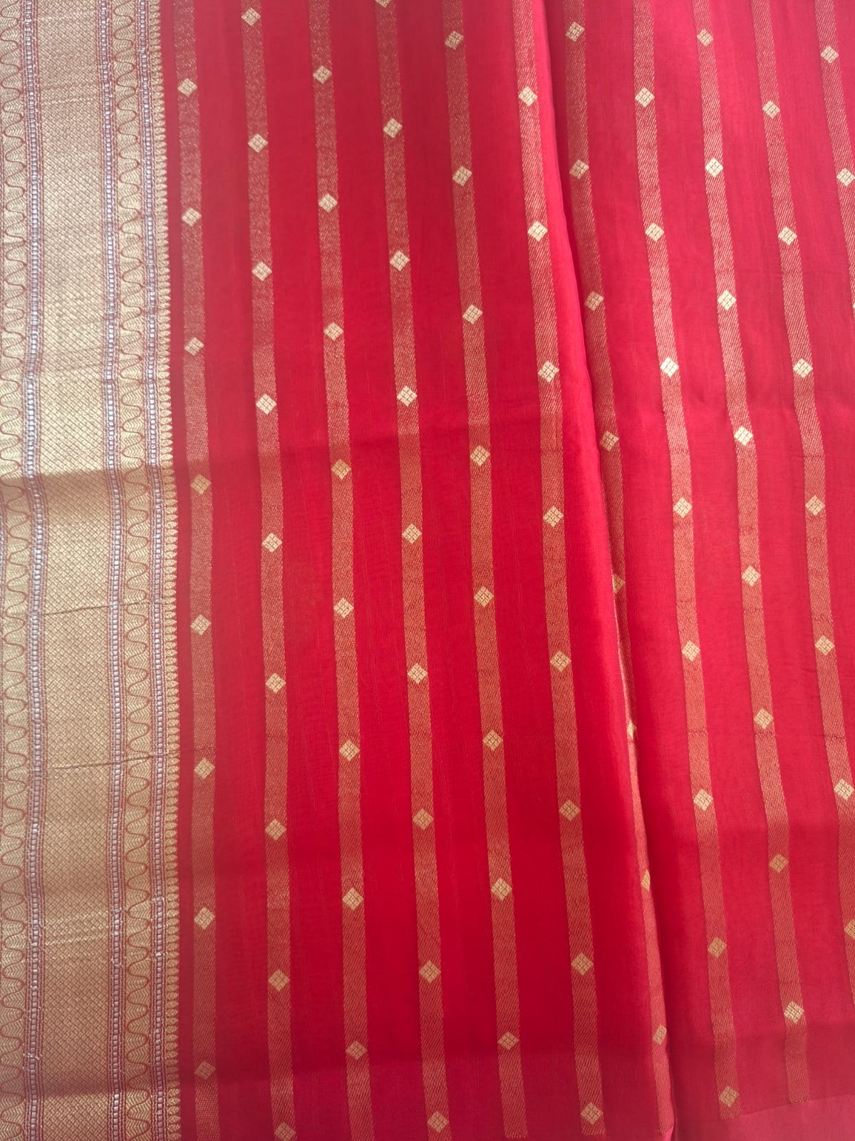 red organza with satin border and copper zari motives