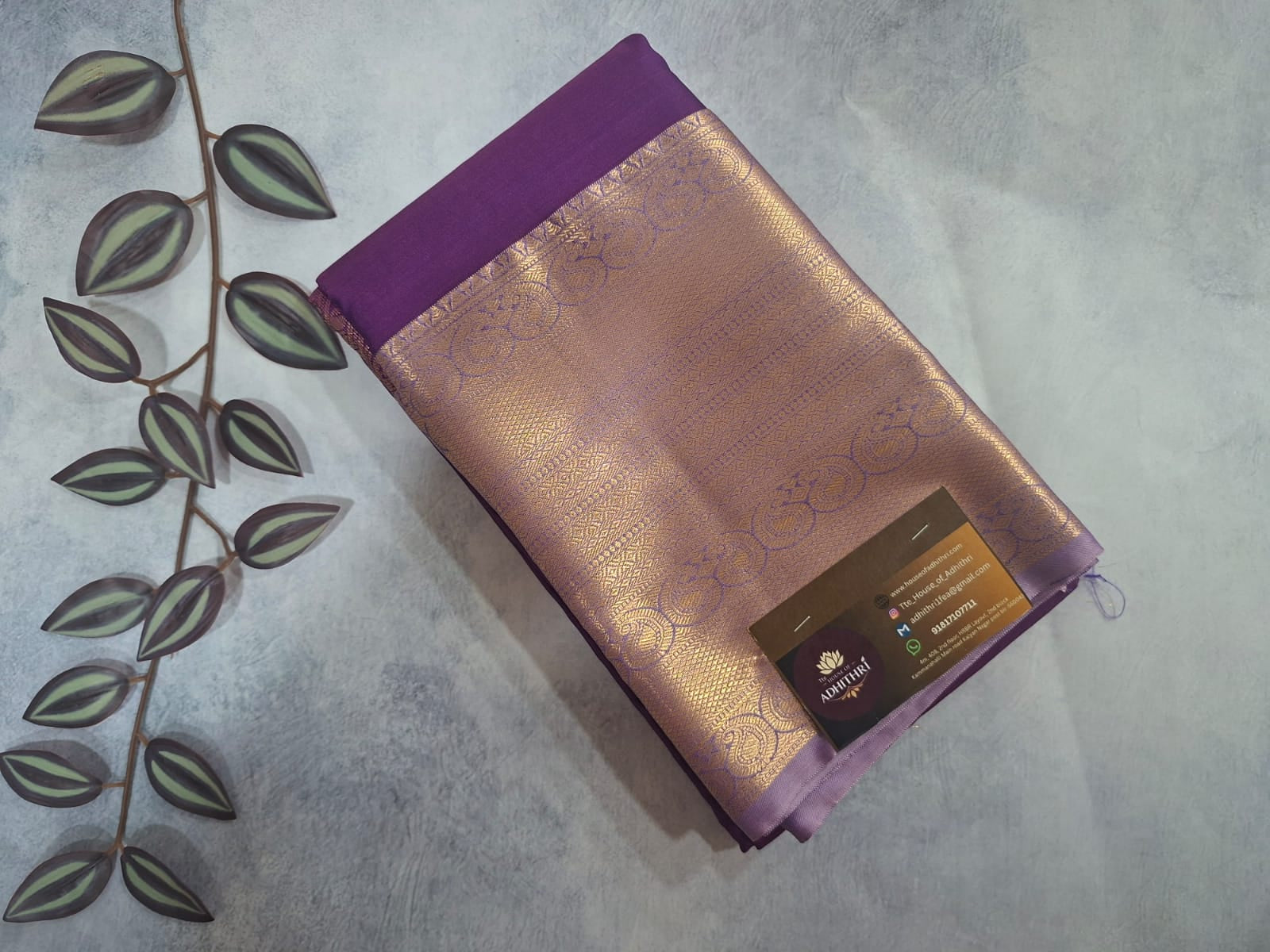 Purple fabric with a brand label on a textured surface