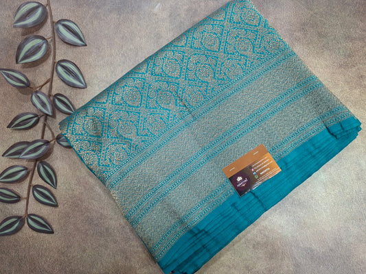 Teal fabric with a pattern on a beige surface