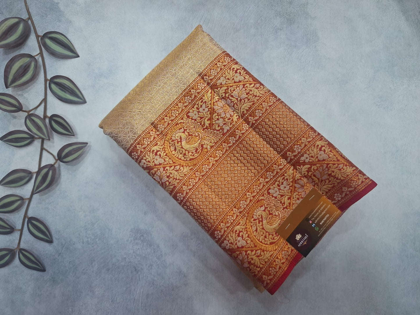 Decorative folded fabric with intricate patterns on a light gray background