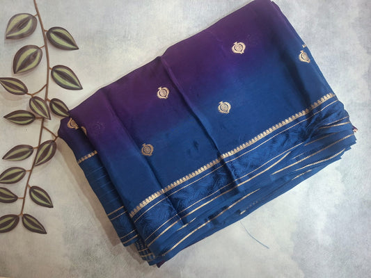 Blue saree with gold border on a light gray background