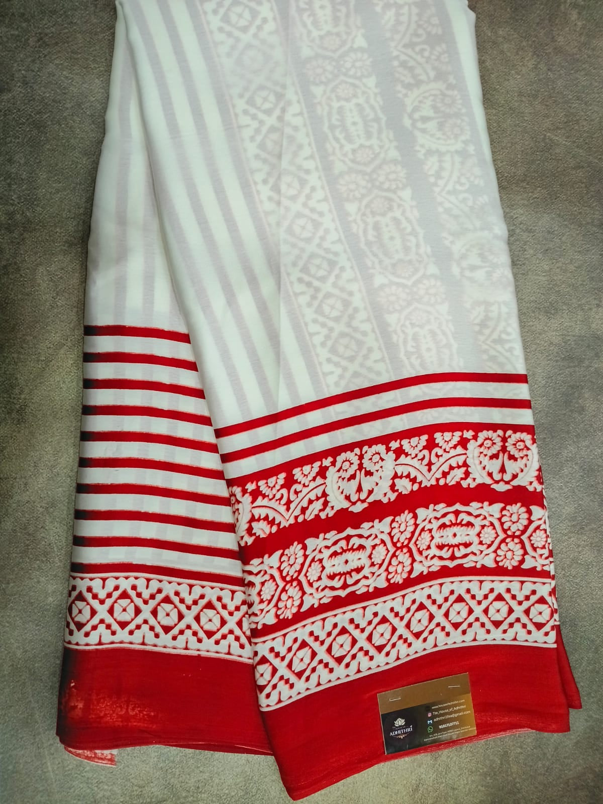 Red and white patterned fabric on a gray surface