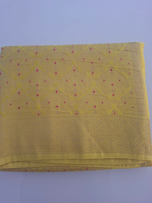 Yellow fabric with a subtle pattern on a light purple background