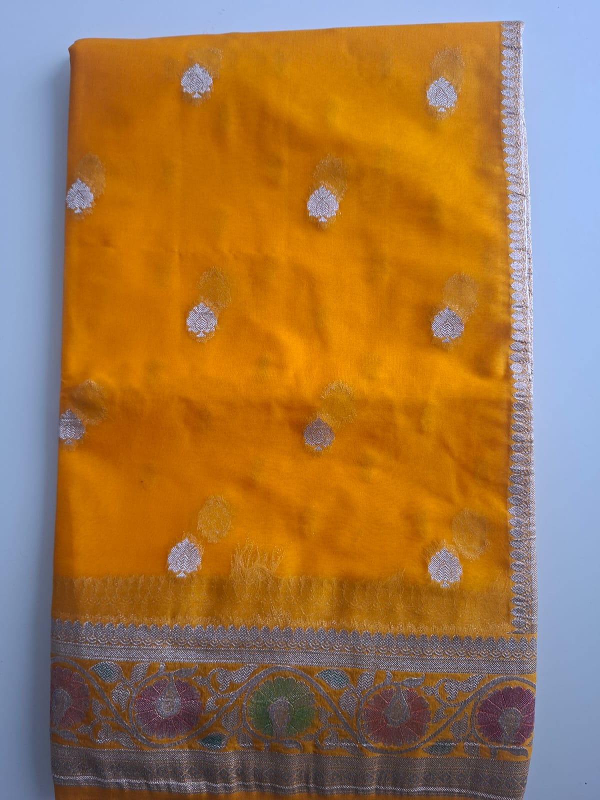 yellow semi chiffon meenakari border saree