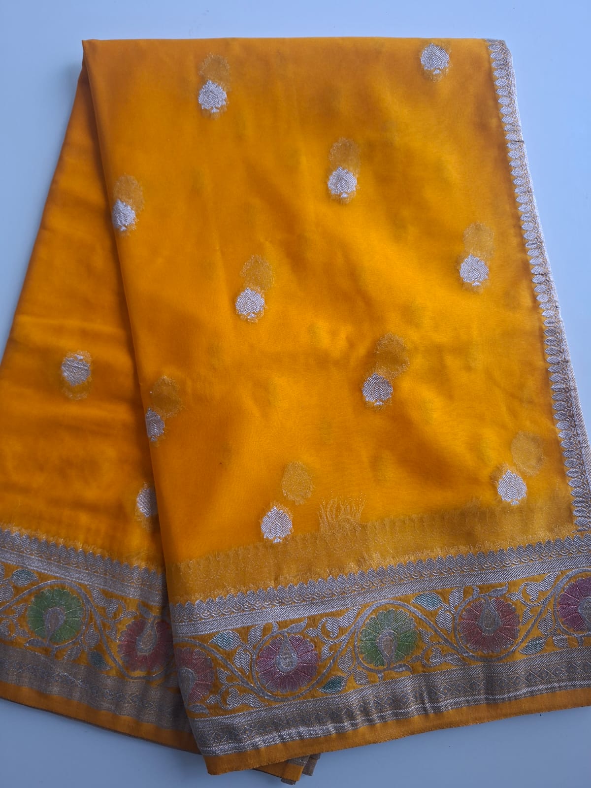 yellow semi chiffon meenakari border saree