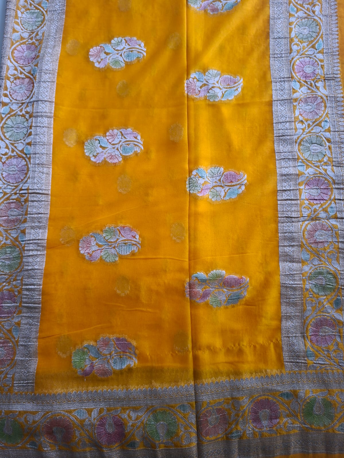 yellow semi chiffon meenakari border saree